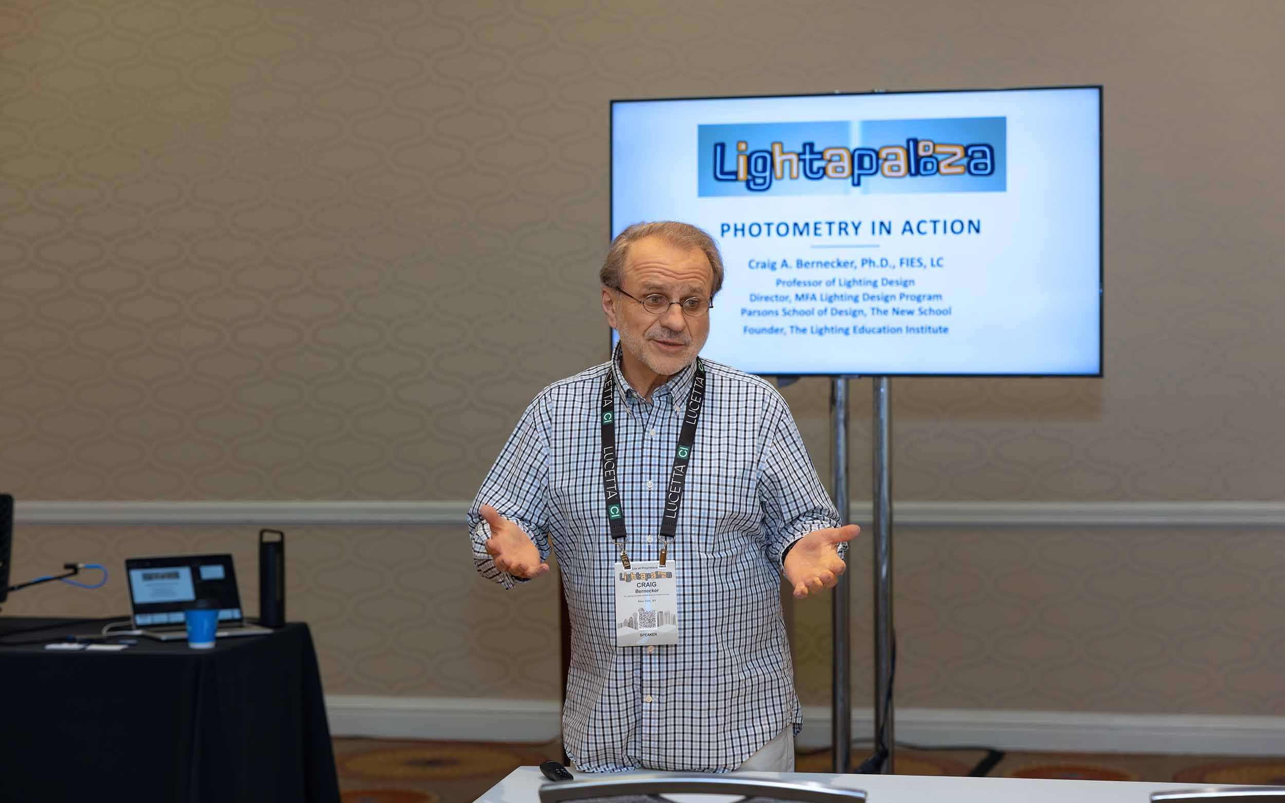 Man lecturing in front of a class about photometry
