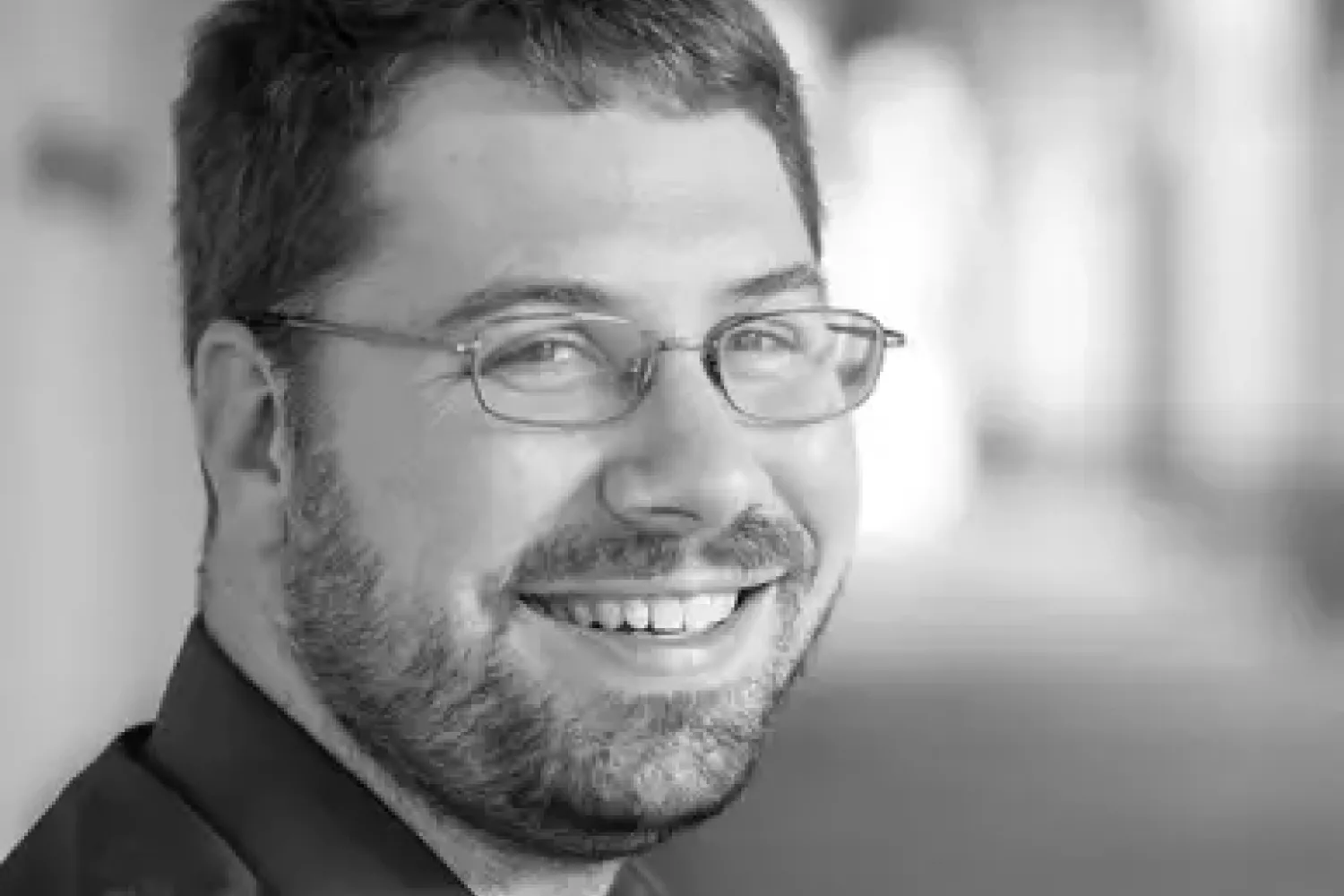 blonde woman with sunglasses laughing as she looks to her right