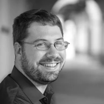 Black-and-white portrait of a Lightapalooza team member, Greg Barrett